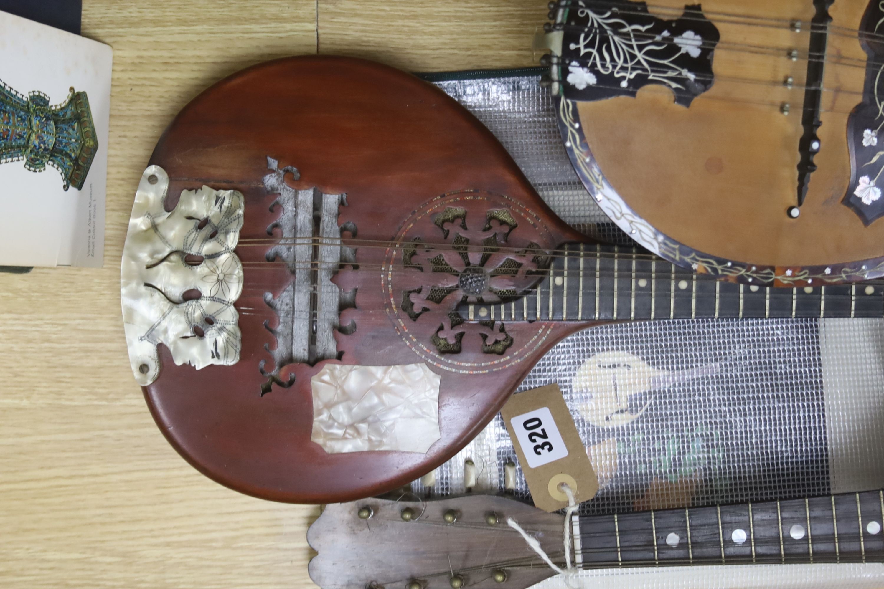 Three Neapolitan mandolins with inlaid mother of pearl decoration, one of round-backed form, the other two archtop